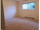 Clean bedroom with neutral carpet and a large window at 7 Shepherd Ln # Bldg D, Chapel Hill, NC 27514