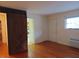 Open-concept room with hardwood floors and rustic barn door, offering ample space at 7 Shepherd Ln # Bldg D, Chapel Hill, NC 27514