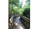 Picturesque wooden walking path surrounded by lush greenery and trees offers a serene outdoor experience at 7 Shepherd Ln # Bldg D, Chapel Hill, NC 27514