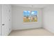 Bedroom featuring large window with neighborhood view, carpet and door at 7370 Michelle Rd, Rocky Mount, NC 27803