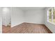Bright, airy bedroom featuring neutral walls, wood-look floors and a large window at 7370 Michelle Rd, Rocky Mount, NC 27803