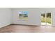Bright bedroom with laminate flooring, large windows, and sliding glass door at 7370 Michelle Rd, Rocky Mount, NC 27803