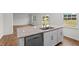 Kitchen island features granite countertop, stainless steel dishwasher, sink and white cabinets at 7370 Michelle Rd, Rocky Mount, NC 27803