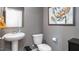 Charming powder room featuring a pedestal sink, toilet, and stylish gray paint at 7384 Michelle Rd, Rocky Mount, NC 27803