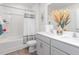Bright bathroom with double sink vanity, framed mirror, tub with shower, and stylish decor at 7384 Michelle Rd, Rocky Mount, NC 27803