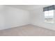 A bedroom with natural light from a window and neutral carpet, perfect for relaxation and rest at 7384 Michelle Rd, Rocky Mount, NC 27803