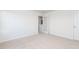 An empty bedroom featuring neutral carpet, an open french door, and crisp white walls at 7384 Michelle Rd, Rocky Mount, NC 27803