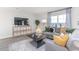 Bright living room boasts a large window, stylish console with TV, and a comfortable grey couch at 7384 Michelle Rd, Rocky Mount, NC 27803