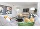 Inviting living room with gray sofa, modern console, and statement artwork, creating a cozy atmosphere at 7384 Michelle Rd, Rocky Mount, NC 27803