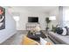 Open living room featuring a console with TV, grey couch, and an area rug in a stylish home at 7384 Michelle Rd, Rocky Mount, NC 27803