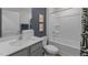 Well-lit bathroom with white tub/shower, grey vanity, and modern fixtures at 7400 Michelle Rd, Rocky Mount, NC 27803