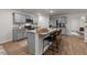 Modern kitchen with gray cabinets, granite countertops, and a large center island at 7400 Michelle Rd, Rocky Mount, NC 27803