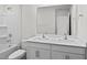 Well-lit bathroom showcasing double sinks, a shower-tub combo, and modern fixtures at 7416 Michelle Rd, Rocky Mount, NC 27803
