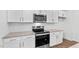 Well-equipped kitchen featuring stainless steel appliances, white cabinets, and stone countertops for a modern look at 7416 Michelle Rd, Rocky Mount, NC 27803
