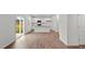 Bright open-concept living space featuring wood floors, a sliding glass door, and a modern kitchen at 7416 Michelle Rd, Rocky Mount, NC 27803