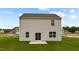 Back exterior view of house, featuring a patio and lawn at 7439 Michelle Rd, Rocky Mount, NC 27803