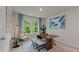Bright office features a large window with green views, a wooden table, and blue accents at 7475 Michelle Rd, Rocky Mount, NC 27803
