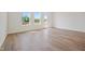 Living area with laminate flooring, bright windows, and a door to a small deck space at 751 Parc Townes Dr # 32, Wendell, NC 27591