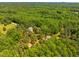 An aerial view featuring multiple homes nestled within a dense, mature tree canopy at 815 Solitude Pt, Chapel Hill, NC 27516