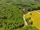 Scenic aerial view of a property surrounded by lush greenery and a winding driveway at 815 Solitude Pt, Chapel Hill, NC 27516
