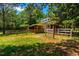 Exterior view of barn with fencing and well-maintained green grass at 815 Solitude Pt, Chapel Hill, NC 27516