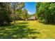 Exterior view of barn with fencing surrounded by trees and green grass at 815 Solitude Pt, Chapel Hill, NC 27516