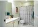 Bathroom featuring a vanity with a sink, a toilet, and a shower with a multicolored polka-dot shower curtain at 815 Solitude Pt, Chapel Hill, NC 27516