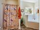 Bathroom featuring a shower, tub, and patterned shower curtain by the window at 815 Solitude Pt, Chapel Hill, NC 27516