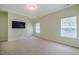 Spacious bonus room with neutral carpet, a TV, and windows with blinds, offering versatility and comfort at 815 Solitude Pt, Chapel Hill, NC 27516