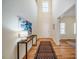 A bright and airy entryway featuring hardwood floors, a patterned rug, and soaring ceilings at 815 Solitude Pt, Chapel Hill, NC 27516