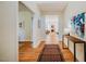 Well-lit entryway featuring hardwood floors, patterned rug, and an open layout leading to other rooms at 815 Solitude Pt, Chapel Hill, NC 27516