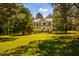 Beautiful two-story home with a sprawling lawn, mature trees, and a serene setting at 815 Solitude Pt, Chapel Hill, NC 27516