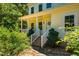 Inviting home entrance with a charming porch, brick steps, classic white railings and attractive landscaping at 815 Solitude Pt, Chapel Hill, NC 27516