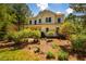 Charming two-story home with a well-manicured yard, mature trees, and a welcoming front porch at 815 Solitude Pt, Chapel Hill, NC 27516