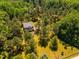 Aerial view of house surrounded by dense green trees at 815 Solitude Pt, Chapel Hill, NC 27516