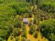 Aerial view of house and yard surrounded by dense green trees at 815 Solitude Pt, Chapel Hill, NC 27516