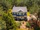 Aerial view of house and yard surrounded by trees at 815 Solitude Pt, Chapel Hill, NC 27516