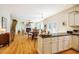 Open layout connects kitchen to dining and living area featuring hardwood floors and natural lighting at 815 Solitude Pt, Chapel Hill, NC 27516