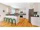 Spacious kitchen features white cabinets, stainless appliances, breakfast bar, and hardwood floors at 815 Solitude Pt, Chapel Hill, NC 27516