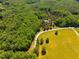 Aerial view of a sprawling wooded area with a house and long driveway at 815 Solitude Pt, Chapel Hill, NC 27516