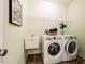 Well-equipped laundry room includes a washer, dryer, utility sink and storage at 815 Solitude Pt, Chapel Hill, NC 27516