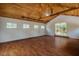 Spacious room with wood flooring, vaulted wood ceiling, and glass door to outdoors at 815 Solitude Pt, Chapel Hill, NC 27516