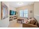 Comfortable living room featuring a sofa, TV, built-in shelves, and natural light at 815 Solitude Pt, Chapel Hill, NC 27516