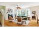 Comfortable living room with a fireplace, large windows, hardwood floors and stylish, neutral-toned furniture at 815 Solitude Pt, Chapel Hill, NC 27516