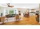 Open-concept living area featuring hardwood floors, large windows and a seamless flow into the dining area at 815 Solitude Pt, Chapel Hill, NC 27516