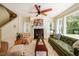Inviting living room features a fireplace, ceiling fan, and large windows offering lots of natural light at 815 Solitude Pt, Chapel Hill, NC 27516