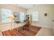 Bright home office featuring natural light from three windows and neutral walls with a colorful area rug at 815 Solitude Pt, Chapel Hill, NC 27516