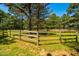 Expansive green pasture enclosed by a wooden fence, ideal for horses or livestock at 815 Solitude Pt, Chapel Hill, NC 27516