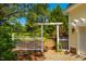 Well-manicured yard with lush greenery, a charming white fence, and an elegant arbor at 815 Solitude Pt, Chapel Hill, NC 27516
