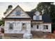 Under-construction home featuring black roof, white windows, and brick foundation on a partially cleared lot at 824 Emmett Ct, Spring Hope, NC 27882